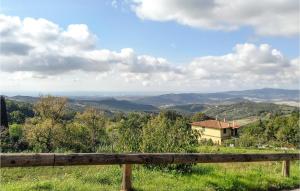 a wooden bench sitting on top of a hill at Cozy Apartment In Castellina Marittima in Castellina Marittima