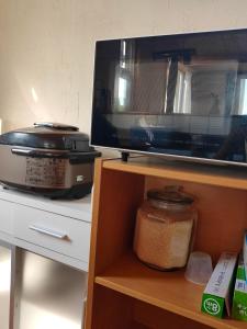a kitchen counter with a microwave and a food processor at Guest House ONLY ONE in Niseko