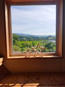 two starfish sitting in a window sill with a view at Guest House ONLY ONE in Niseko