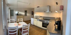 a kitchen with a table and a counter top at Chalet zum See in Bregenz