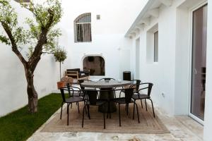 a dining room with a table and chairs at Le Carasse Boutique Hotel in Mola di Bari