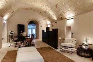 a living room with a couch and a table at Le Carasse Boutique Hotel in Mola di Bari