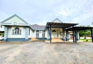 a large white house with a large driveway at Villa Ruby - with private swimming pool in Kota Bharu