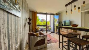 a living room with a bar and a television at Black Forest Villa in Lahr