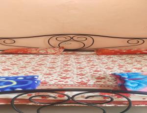 a close up of a bed with a comforter at Hotel Sai Dham, Mandu in Māndu