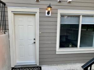 a house with a white door and a window at Spacious Burnaby Guest Home in Burnaby