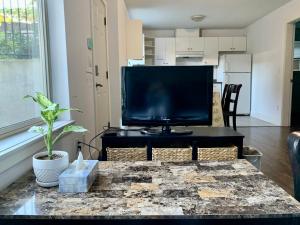 a living room with a flat screen tv on a table at Spacious Burnaby Guest Home in Burnaby