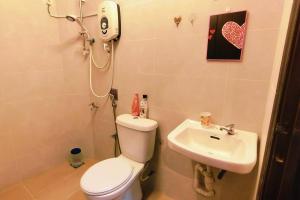 a bathroom with a toilet and a sink at 46 Jb Tmn Century 5Room 18pax near CIQ KSL Mall in Johor Bahru