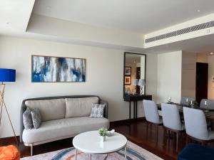 a living room with a couch and a table at Cinnamon Life - Luxury 2 Bedroom Apartment. in Colombo