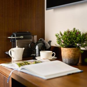 a table with two coffee cups and a book on it at Trinity Townhouse Hotel in Dublin