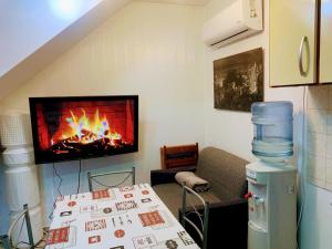 a room with a fireplace and a bed with a table at Encantadora CasaRural Villa Juan in Corme-Puerto