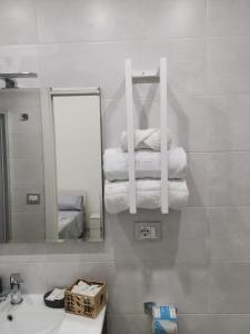 a bathroom with a sink and a mirror and towels at DG Sweet Home in Naples +34 photos