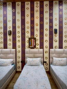 A bed or beds in a room at Riad Najiba