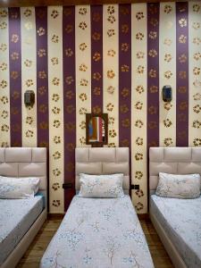 a bedroom with two beds and a wall at Riad Najiba in Rabat +85 photos