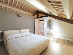 a bedroom with a large white bed in a room at CasaDei Home Design & Relax in Cervia