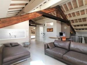 a living room with a leather couch and a table at CasaDei Home Design & Relax in Cervia