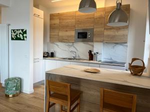 a kitchen with wooden cabinets and a counter top at CaseMaggi Sea View Terrace in Portovenere