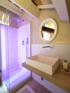a bathroom with a sink and a mirror at CasaDei Home Design & Relax in Cervia