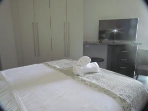 a bedroom with a bed with a towel on it at 210 at Ocean in Cape Town