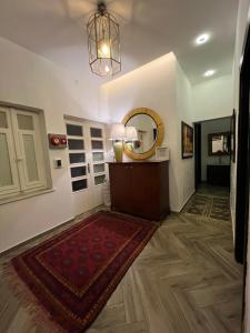 a hallway with a room with a rug and a mirror at Bonita Inn in Amman