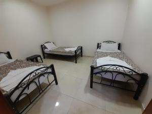 A bed or beds in a room at Farah Plaza Hostel &Hotel Apartments