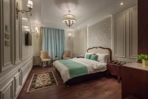 a bedroom with a bed and a chandelier at Miramar Boutique Hotel in Alexandria