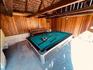 a pool table in the middle of a room at Countryside house with 3 bedrooms in Bonţeşti +11 photos