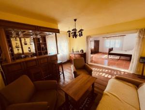 a living room with a couch and a table at Countryside house with 3 bedrooms in Bonţeşti