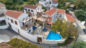 an aerial view of a house with a swimming pool at GrapeVine Villa in Gavalochori