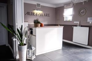 a white counter in a room with plants in it at Willa Aura Mare in Dziwnów