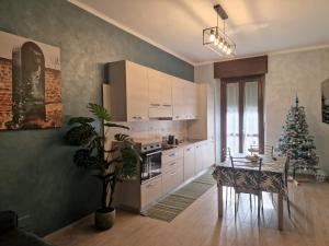 a kitchen with a table and a christmas tree in it at Borgo Vittoria House in Turin