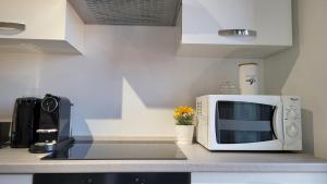 A kitchen or kitchenette at Milano City Apartments - Stylish House Free WiFi-Parking-Airport