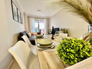 a dining room with a wooden table and white chairs at Magnificent apartment Mar'y'Golf with SPECTACULAR VIEW! High-speed internet, Remote Work in Mojácar