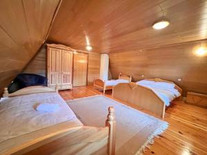 ヴラシチにあるPlaninska Koliba Vlašićの木造キャビン内のベッド2台が備わる部屋