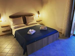 a bedroom with a bed with two slippers on it at Residenza Matilde in Fiumefreddo Bruzio