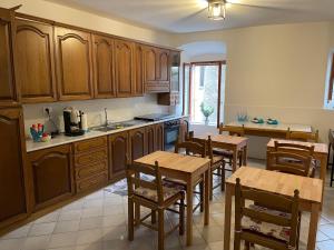 a kitchen with wooden cabinets and wooden tables and chairs at Residenza Matilde in Fiumefreddo Bruzio