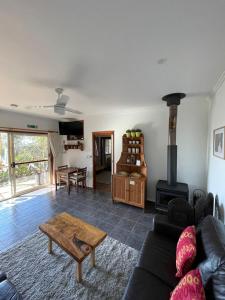 a living room with a couch and a wood stove at Tunnel Ridge Outlook in Mooloolah