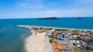 an aerial view of a beach with buildings and the ocean at Hotel Bandeirantes da Barra in Balneario Barra do Sul