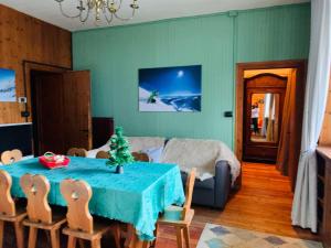 a dining room with a table with a christmas tree on it at Villa Tancredi in Courmayeur