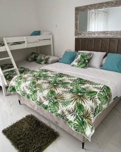 a bedroom with two beds and a bunk bed at apartment Julija in Okrug Donji