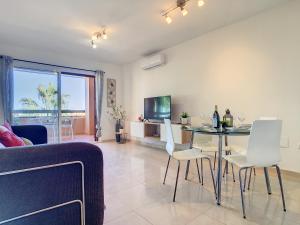 a living room with a table and white chairs at Arona 2 - 5907 in Mar de Cristal