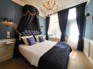 Postel nebo postele na pokoji v ubytování Boutique Hotel Huys van Leyden