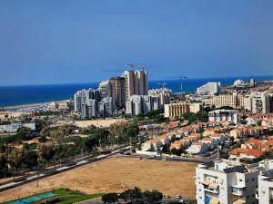 an aerial view of a city with buildings and the ocean at Samson in Ashkelon