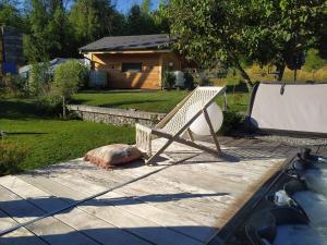 a bench sitting on a deck next to a pool at Maisonnette in Talloires