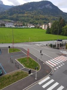 an empty street with a crosswalk in a city at grand studio dans une résidence prive avec une cuisine et salle de bain séparé un parking gratuit et une magnifique vue sur les montagness in Marnaz