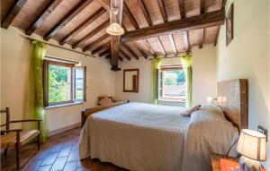 a bedroom with a large bed and two windows at Fico, Oliva, Mora in Calzolaro