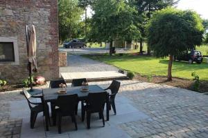 a black table and chairs on a patio at La maison de Barbara in Aubel