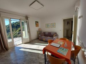 a living room with a table and a couch at Dependance Belvedere in Recco