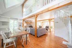 a living room with a table and a couch at Marmora Retreat - Unique Waterfront Farmhouse in Marmora