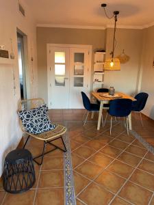 a dining room with a table and chairs in a room at Apartamentos Almerimar Golf in Almerimar